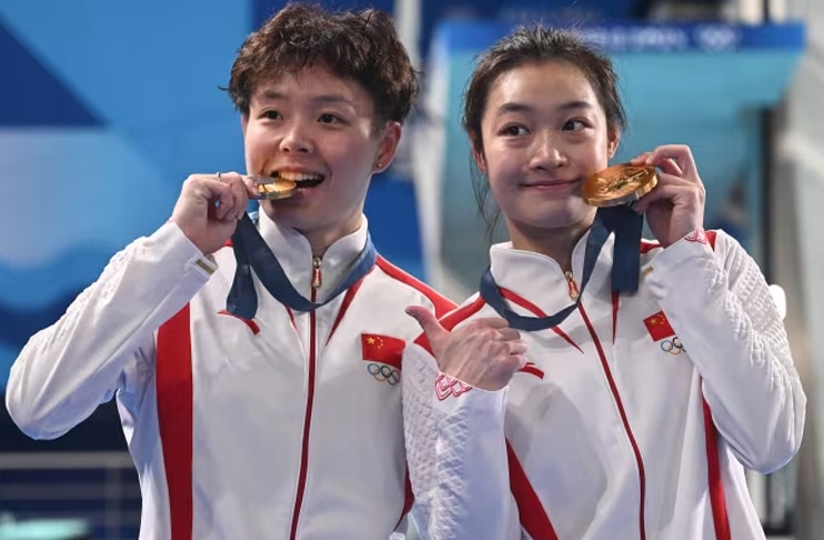 China takes first Olympic gold as rain disrupts Games